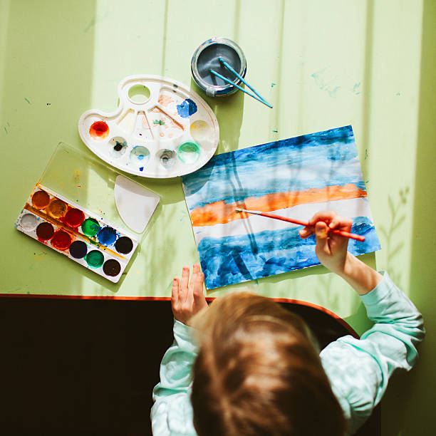 istock Little girl painting 601393034