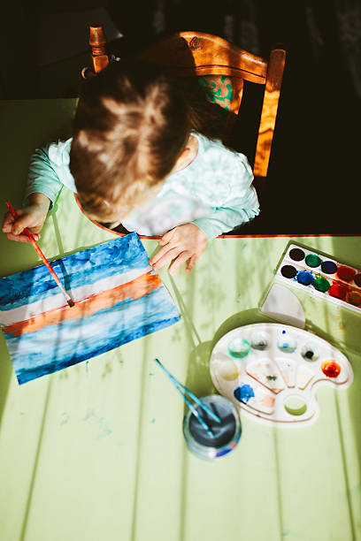 istock Little girl painting 601393090
