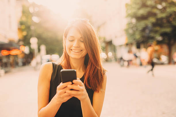 istock Woman texting outdoor 601393284