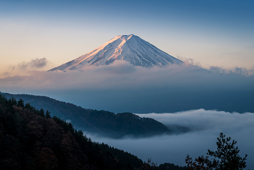 Mount Fuji enshrouded in clouds with clear sky from lake kawaguchi, Yamanashi, Japan
