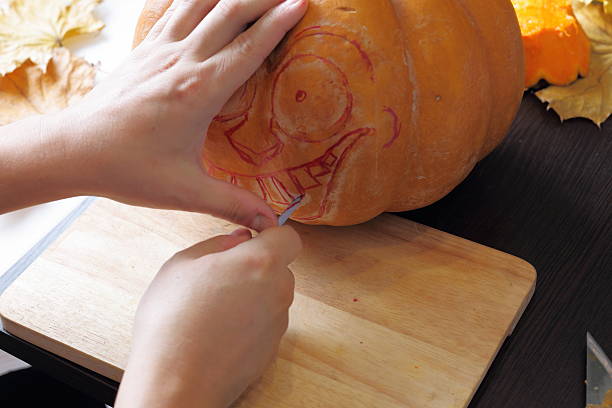 istock Carving out a pumpkin to prepare halloween lantern 601394824