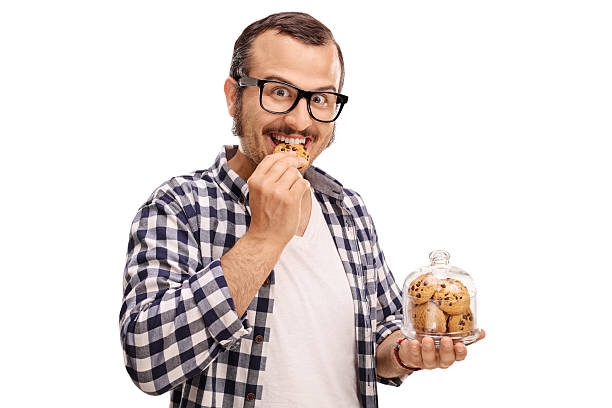 homme souriant mangeant un biscuit - lamb chop photos et images de collection