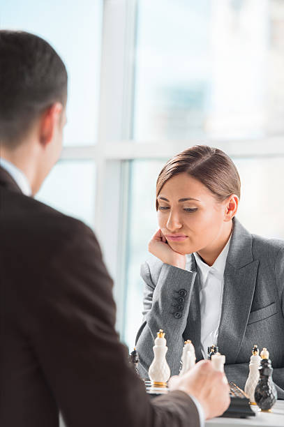 istock Business people playing chess at office. Business strategy 601397794