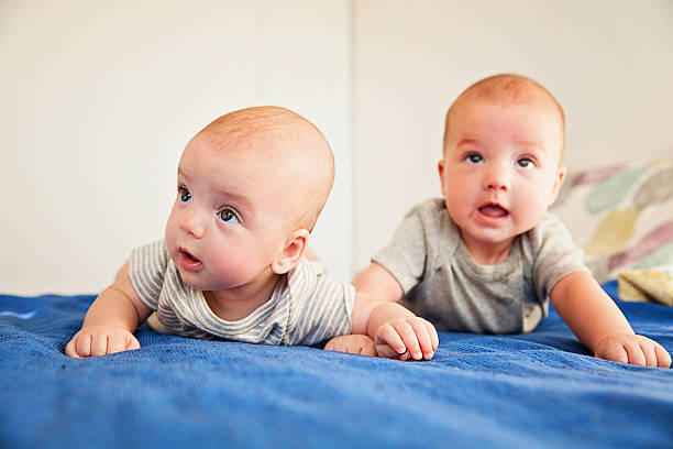 istock Twin baby boys on lying down on bed 601398114