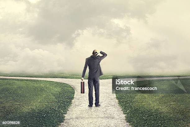 Indecisive And Lost Man Chooses The Right Path Stock Photo - Download Image Now - Choice, Forked Road, Decisions