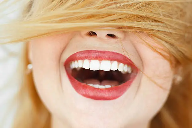 Photo of Happy laughing woman with red hair close-up