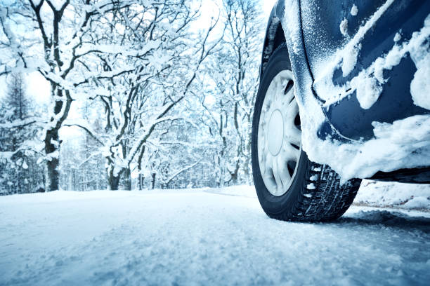 istock Car tires on winter road 601402486