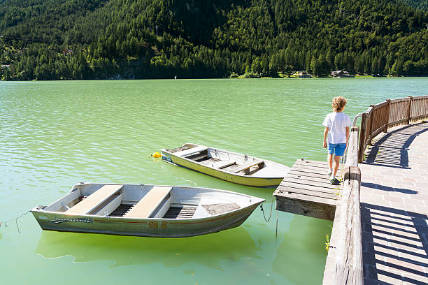 boats on lake of alleghe - cordevole valley imagens e fotografias de stock