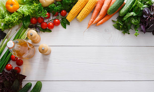 istock Fresh vegetables border on white wood background with copy space 601897848