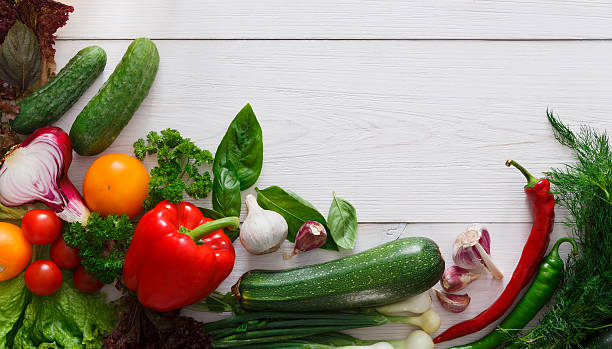 istock Fresh vegetables border on white wood background with copy space 601898644