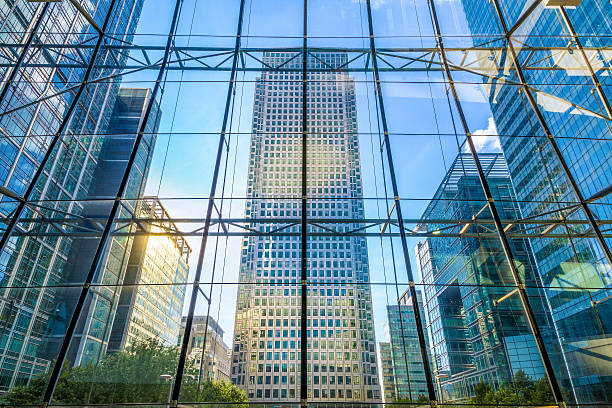 View of office buildings in Canary Wharf View of office buildings through glass window in Canary Wharf, financial district of London canary wharf stock pictures, royalty-free photos & images