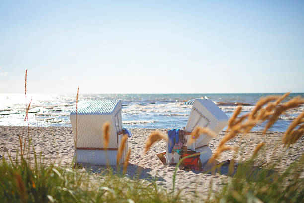 Public Hooded Beach Chair by the water stock photo