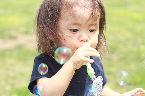 istock Japanese girl playing with bubble (1 year old) 601902296
