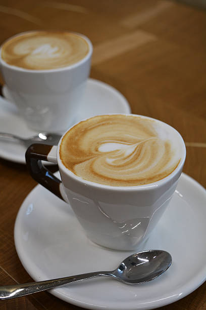 istock Cup of foamy cappuccino on a wooden table 601905954