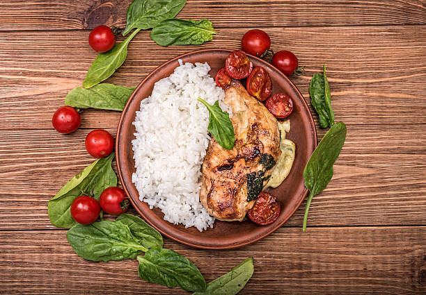 istock Spinach and cheese stuffed chicken breast with rice. 601906452