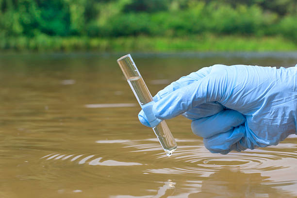istock Sample water from the river for analysis. Hand in glove 601907348