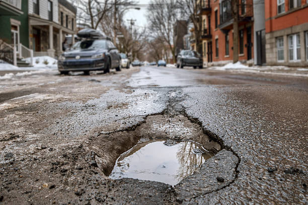 Large deep pothole in Montreal street, Canada. stock photo