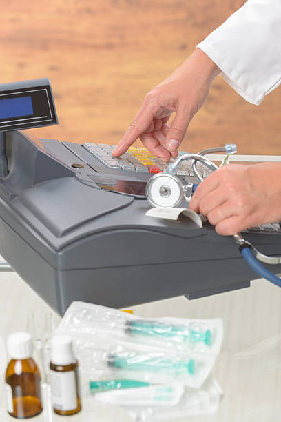 istock pharmacist or medical doctor using cash register 601909594