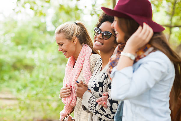 istock Happy woman walking through park 601910282