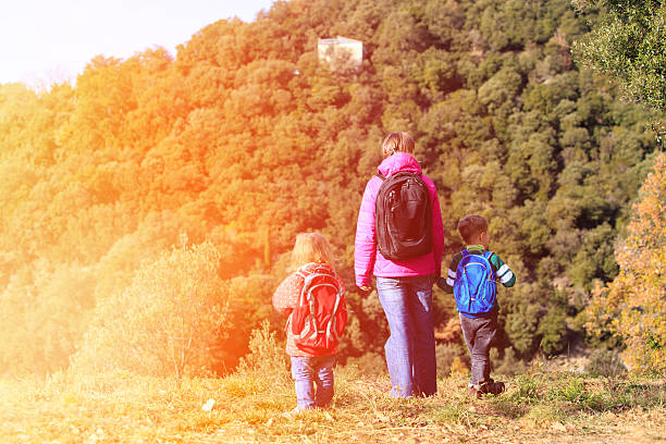 istock mother with two kids travel in mountains 601910404
