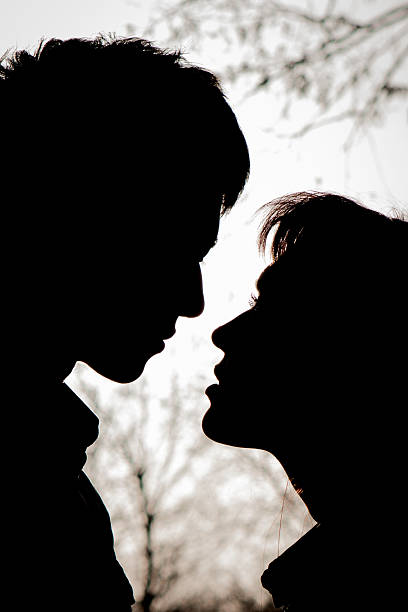 istock Profiles of romantic couple looking at each other 601910572