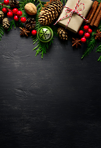 Christmas or New Year dark wooden background, Xmas black board decorated with season decorations, space for a text, view from above