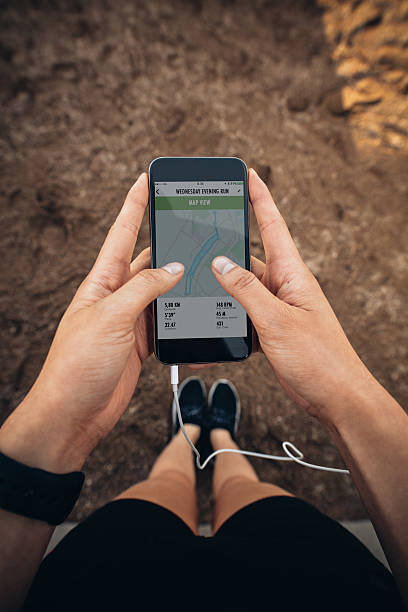 istock Female runner using a fitness app on her mobile phone 601912276