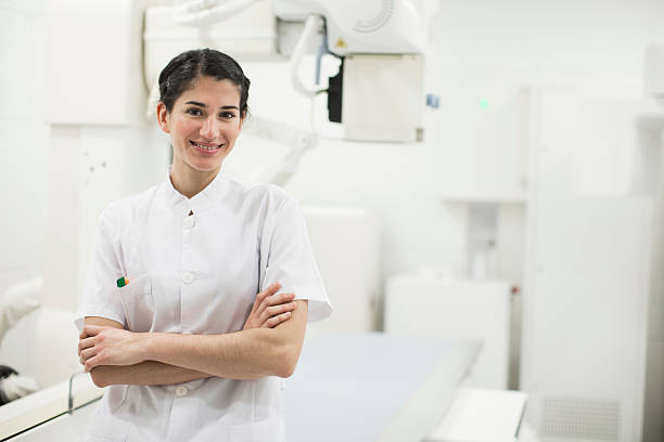 istock Young nurse looking at camera and posing in a hospital 601913332