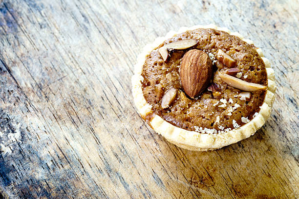 istock Homemade Almonds tart on wooden table background 601913904