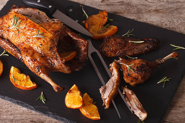 istock Sliced roast duck and closeup on a black slate board 601914354