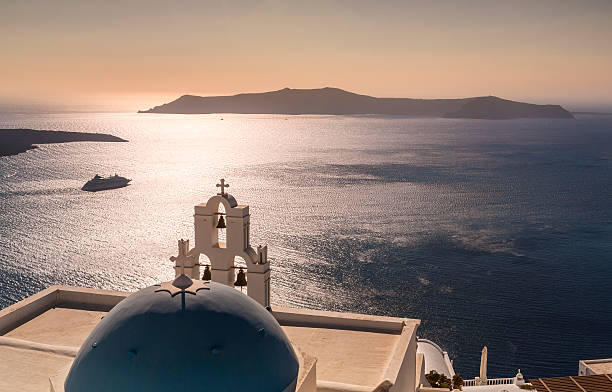 Sunset in Santorini island in Greece with cruise ship