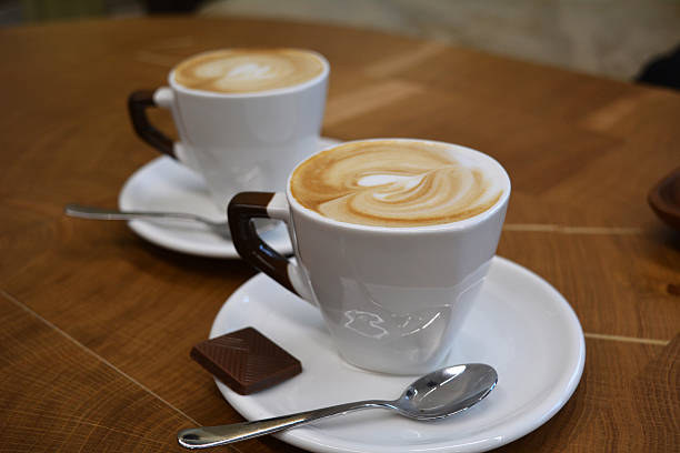 istock Cup of foamy cappuccino on a wooden table 601914542