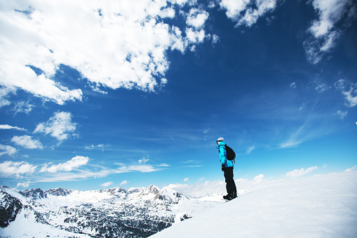 Snowboarder on the edge of the mountain and enjoy the winter landscape. Canillo ski region. Andorra