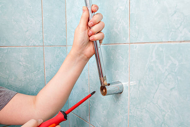 istock Closeup hands uninstalling the broken vertical shower slide bar holder. 601914678
