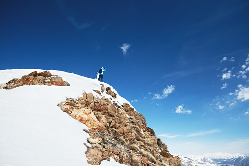 Snowboarder on the edge of the mountain and enjoy the winter landscape. Canillo ski region. Andorra