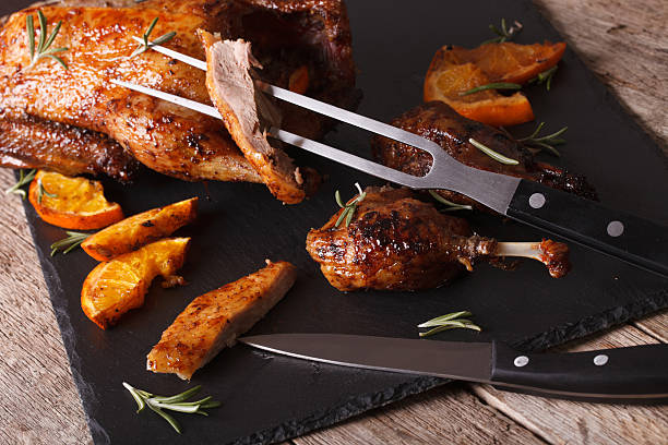 istock Cutting the roast duck close up on a slate board 601915124