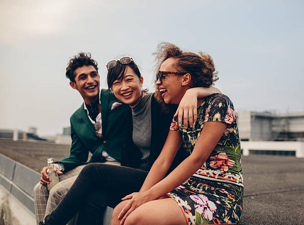 istock Friends laughing together on rooftop 601915538