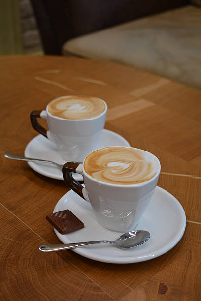 istock Cup of foamy cappuccino on a wooden table 601915588