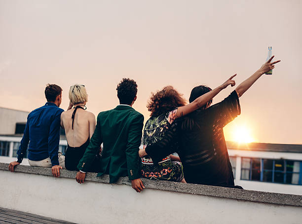 istock Friends enjoying drinks on rooftop at sunset 601915682