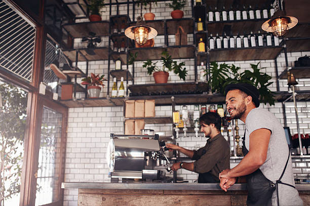 istock Coffee shop owner standing at the counter 601916510