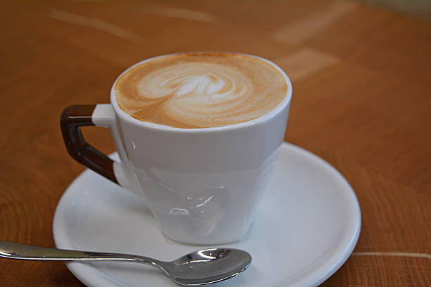 istock Cup of foamy cappuccino on a wooden table 601917194