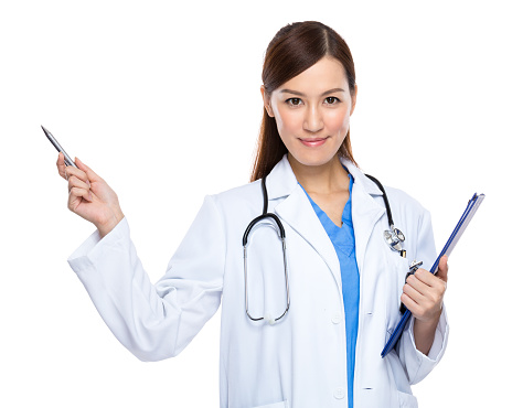 Female doctor holding a clipboard and pointing