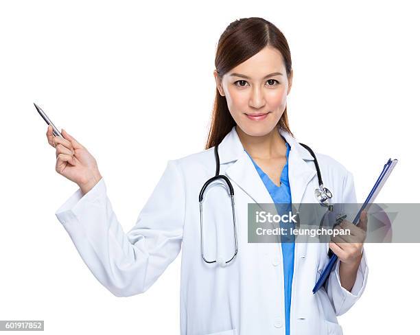 Female Doctor Holding A Clipboard And Pointing Stock Photo - Download Image Now - Doctor, Pointing, Female Doctor
