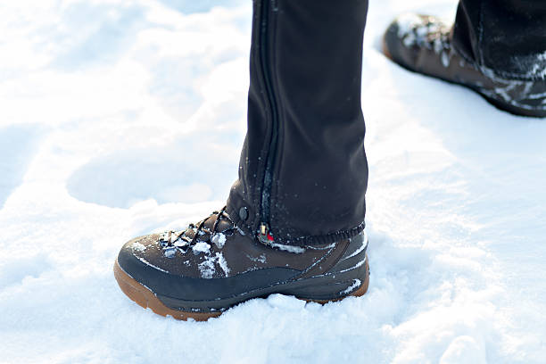 istock Feet in boots on the snow. 601918418