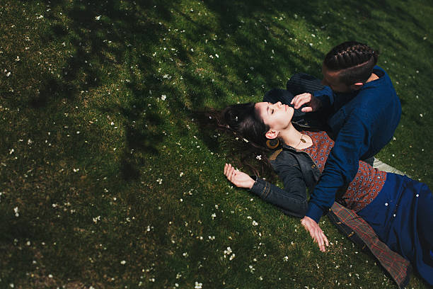 istock Loving couple resting on the lawn 601919392