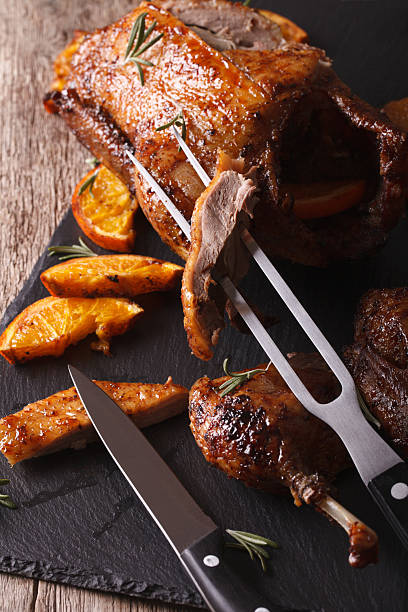 istock Cutting the roast duck close up on a slate board 601919770