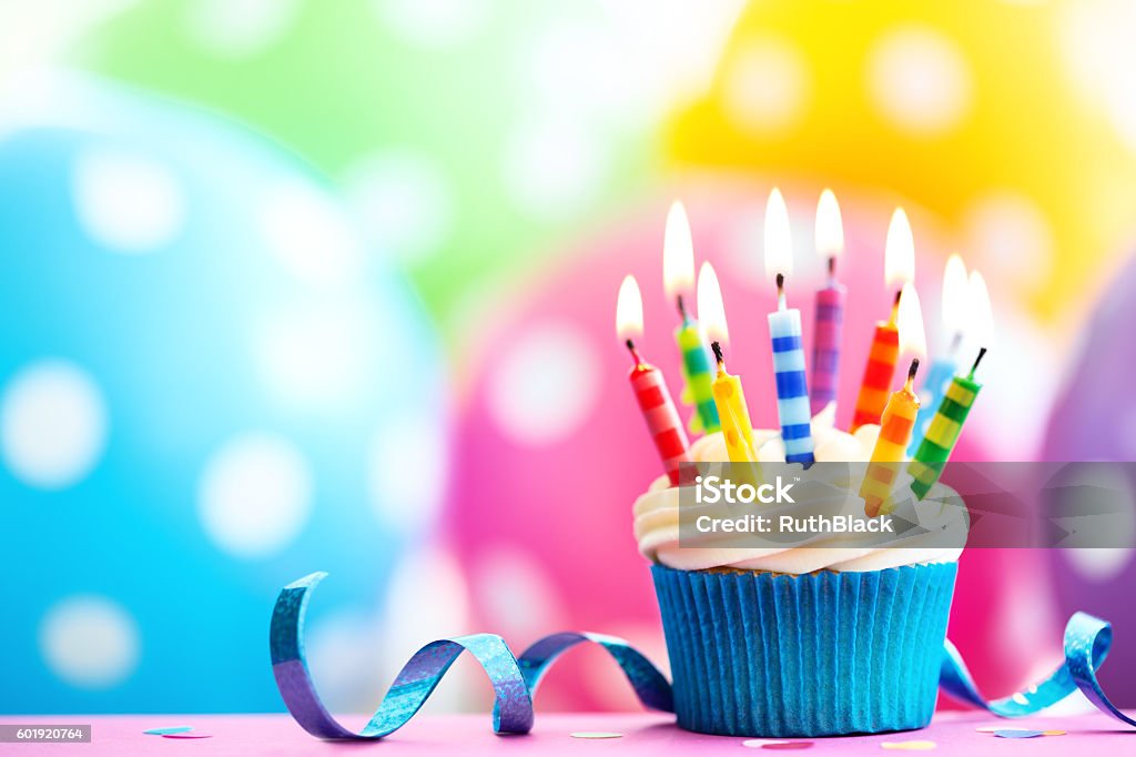 Colorful birthday cupcake Cupcake decorated with colorful birthday candles Birthday Stock Photo