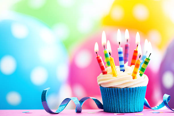 Colorful birthday cupcake Cupcake decorated with colorful birthday candles cupcake stock pictures, royalty-free photos & images