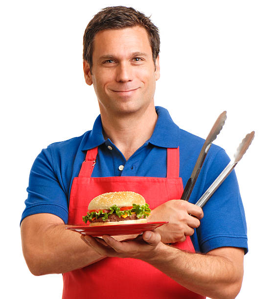 istock Man with Hamburger and Barbeque Tongs on White 601921068