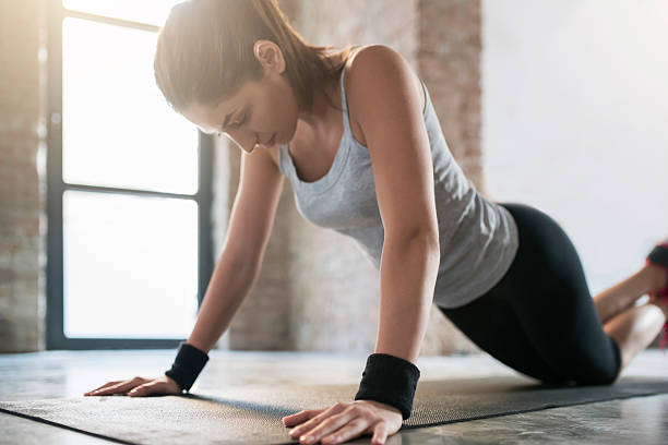 Top Form Young athletic woman doing female push-ups. push ups stock pictures, royalty-free photos & images